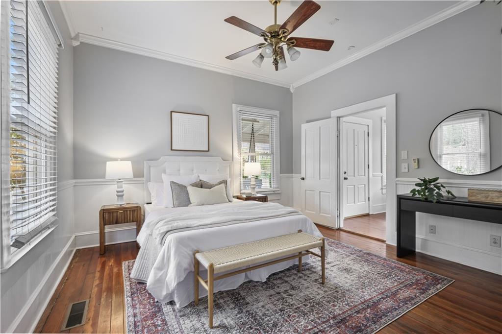 2891 Macaw Street Northwest Atlanta, GA 30318 - Photo 16 of 26 a bedroom with a bed a mirror on dresser and a table