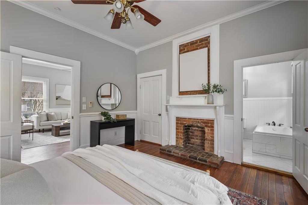 2891 Macaw Street Northwest Atlanta, GA 30318 - Photo 17 of 26 a bedroom with a bed a chandelier and fireplace