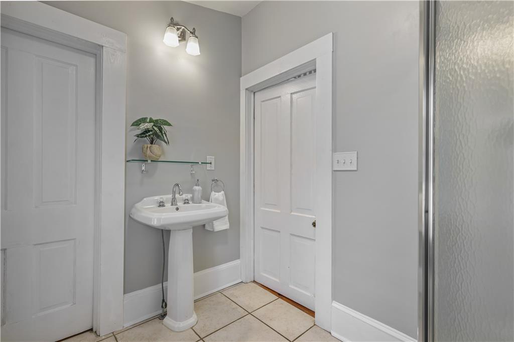 2891 Macaw Street Northwest Atlanta, GA 30318 - Photo 21 of 26 a bathroom with a sink a toilet and a mirror