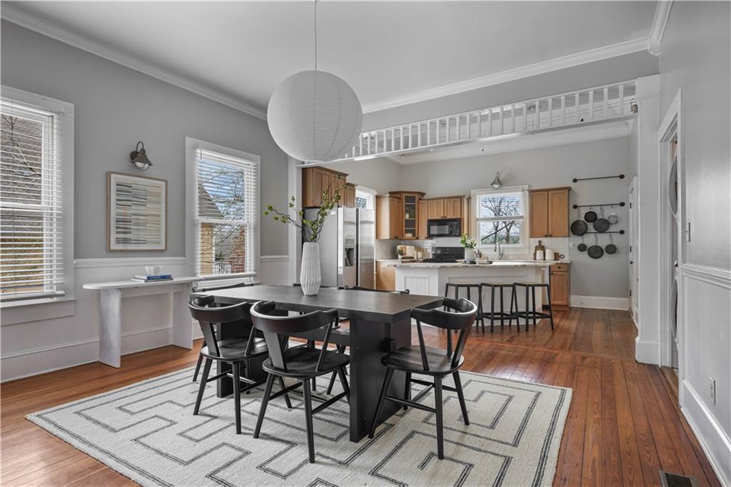 2891 Macaw Street Northwest Atlanta, GA 30318 - Photo 9 of 26 a view of a dining room with furniture window and wooden floor