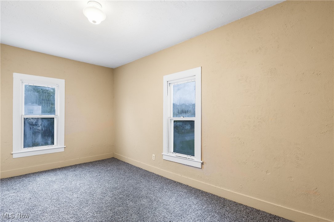 7529 State Line Burghill, OH 44404 - Photo 14 of 23 Empty room featuring baseboards and carpet flooring