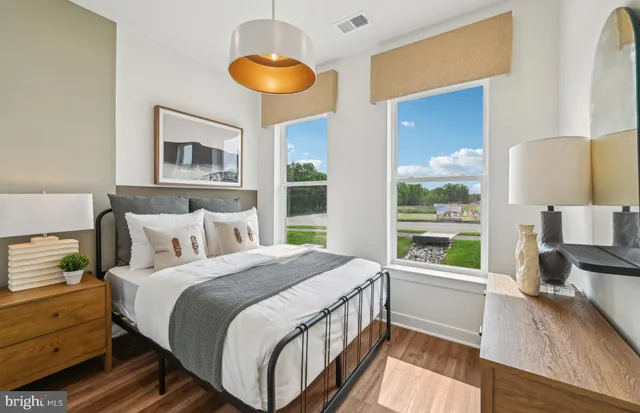 a bedroom with a bed and a large window