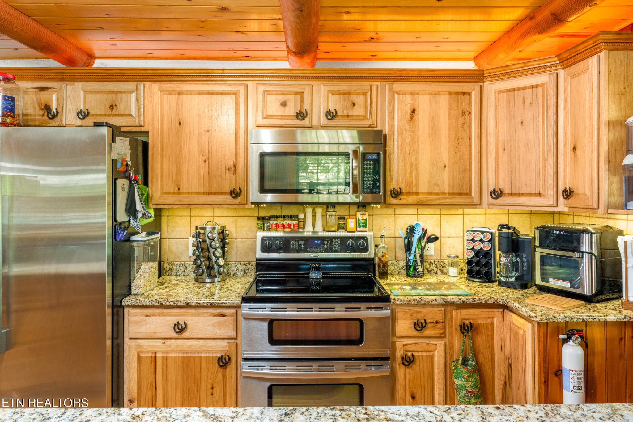 228 Pattie Gap Road Philadelphia, TN 37846 - Photo 12 of 57 a kitchen with stainless steel appliances granite countertop a stove and a refrigerator