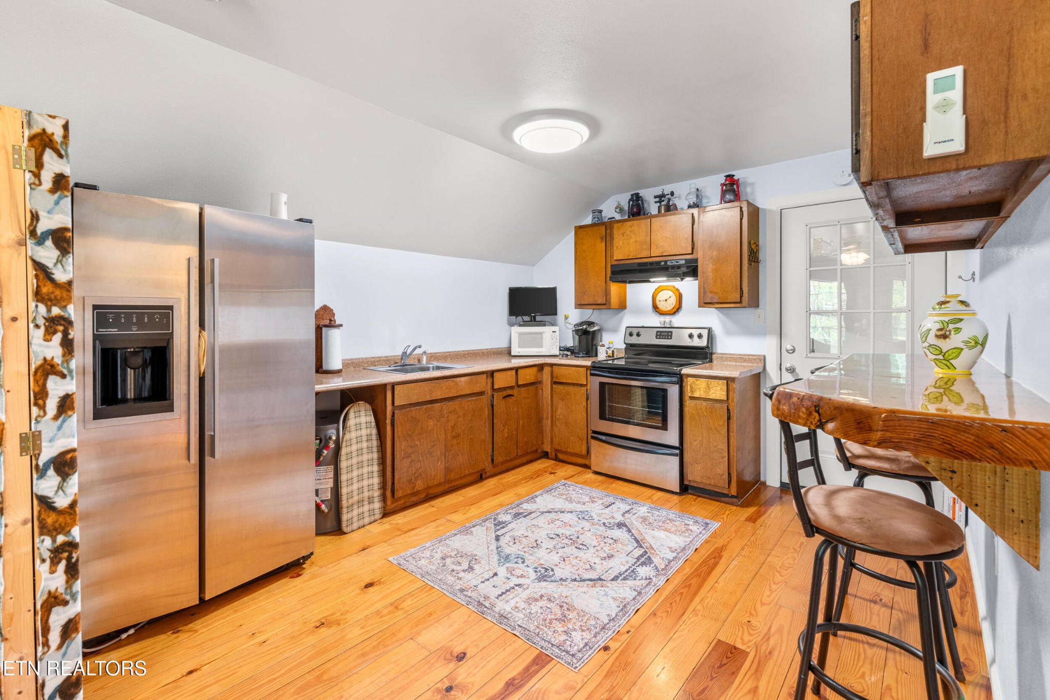228 Pattie Gap Road Philadelphia, TN 37846 - Photo 39 of 57 a kitchen with stainless steel appliances granite countertop a stove a sink dishwasher and a refrigerator