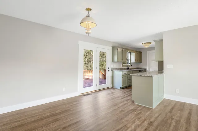 a kitchen with a refrigerator and a stove top oven