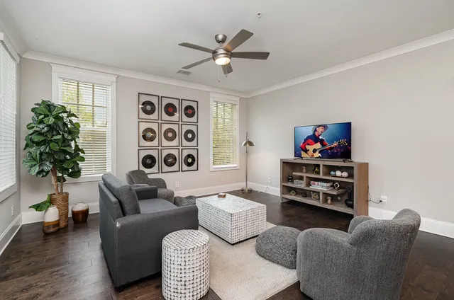 a living room with furniture a chandelier and a window