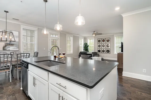 a kitchen with stainless steel appliances granite countertop a sink a stove and a counter space