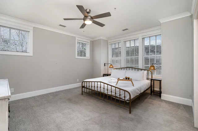 a spacious bedroom with a bed and a window