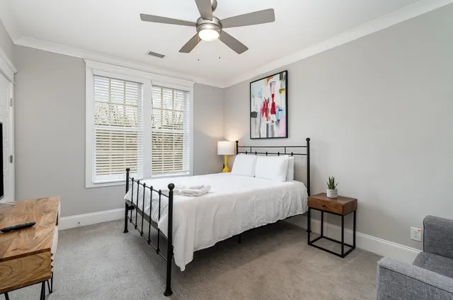 a bedroom with a bed and a chandelier
