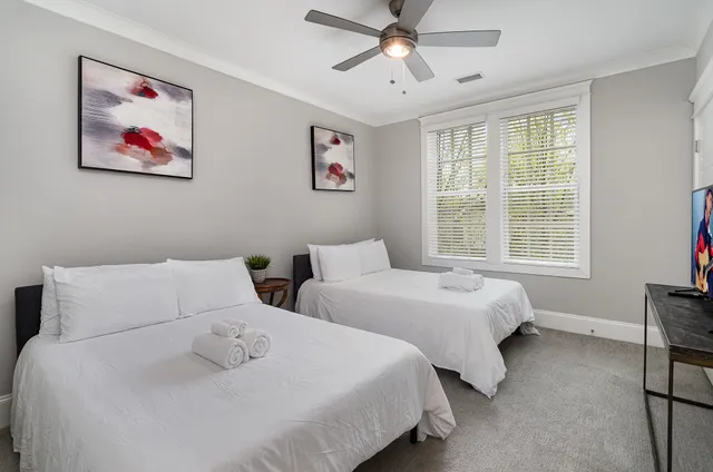 a bedroom with two beds and a window