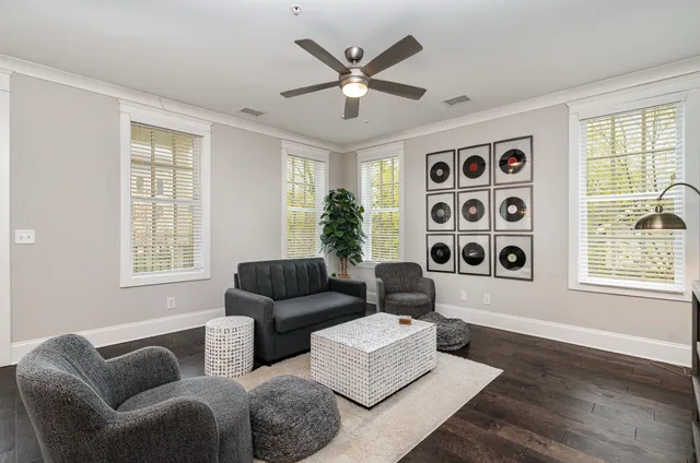 a living room with furniture and a window with garden view