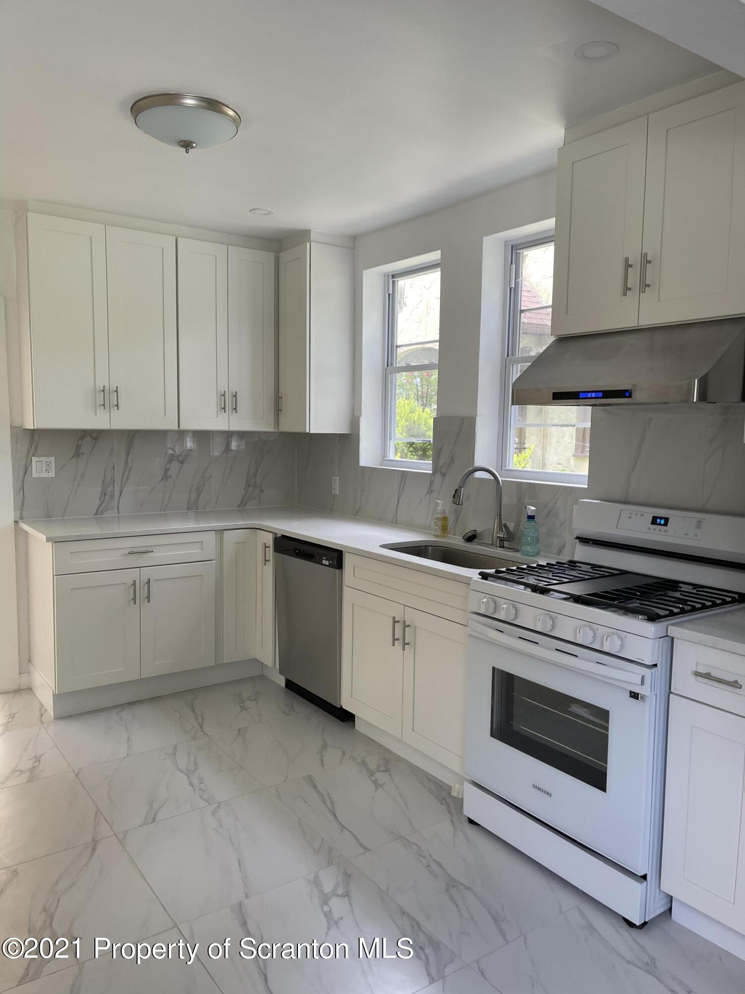 9 Front Street Clarks Summit, PA 18411 - Photo 12 of 22 a kitchen with granite countertop white cabinets and white stainless steel appliances