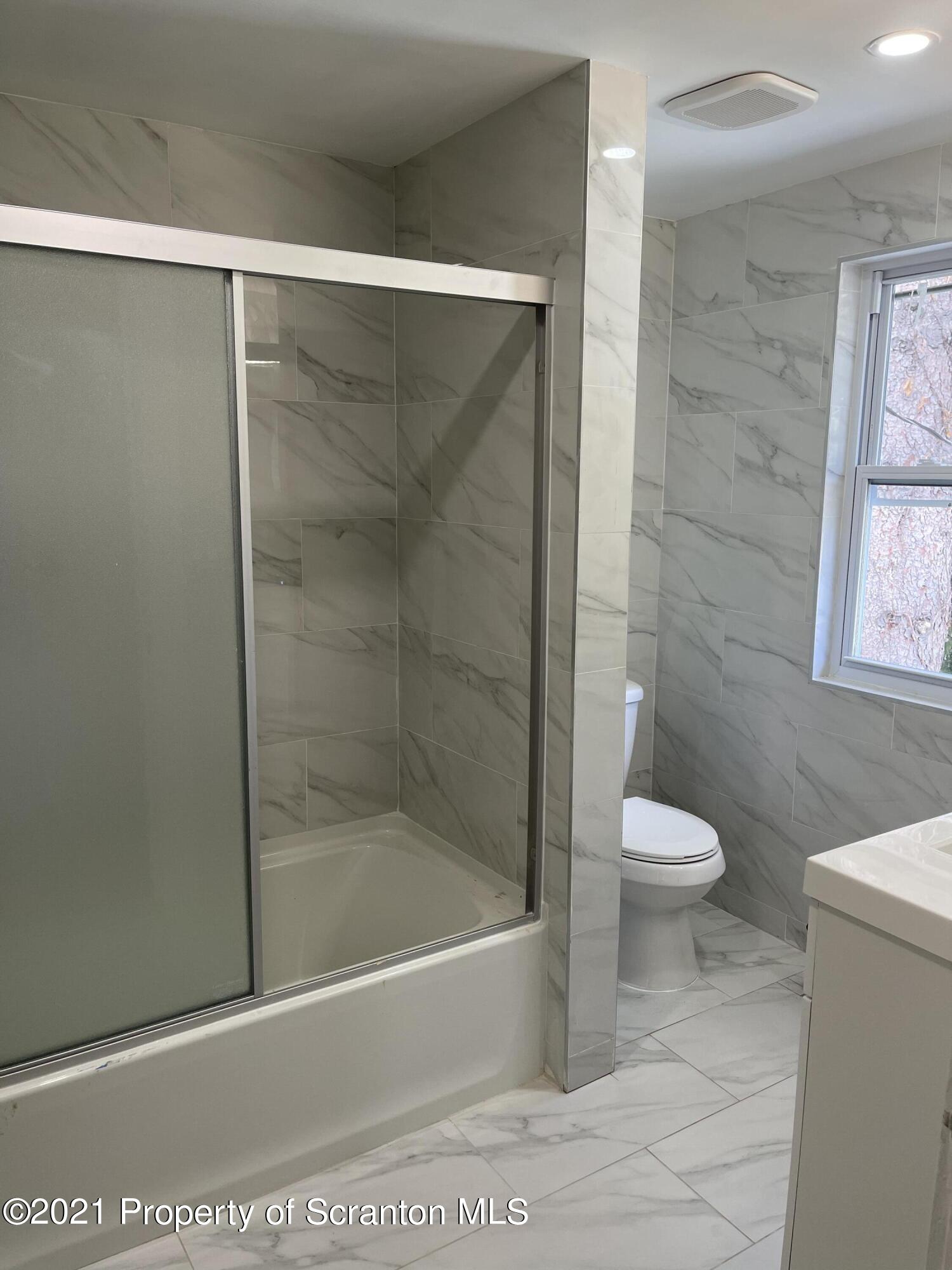 9 Front Street Clarks Summit, PA 18411 - Photo 19 of 22 a bathroom with a shower and a toilet