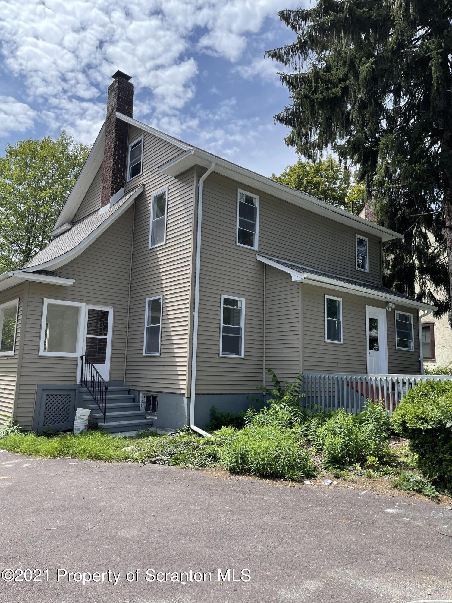 9 Front Street Clarks Summit, PA 18411 - Photo 3 of 22 a front view of a house with garden