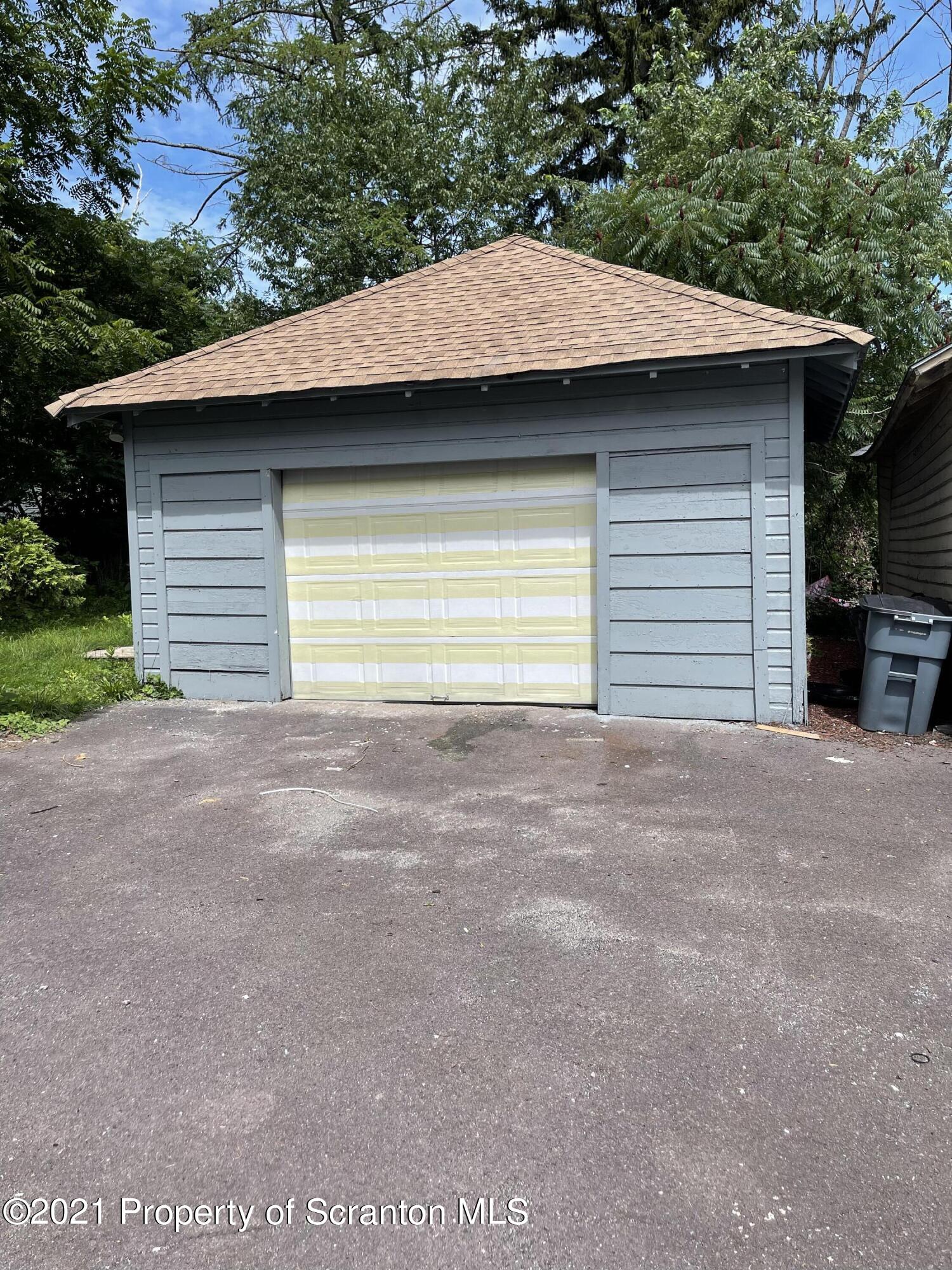 9 Front Street Clarks Summit, PA 18411 - Photo 5 of 22 a view of a house with a garage and a yard