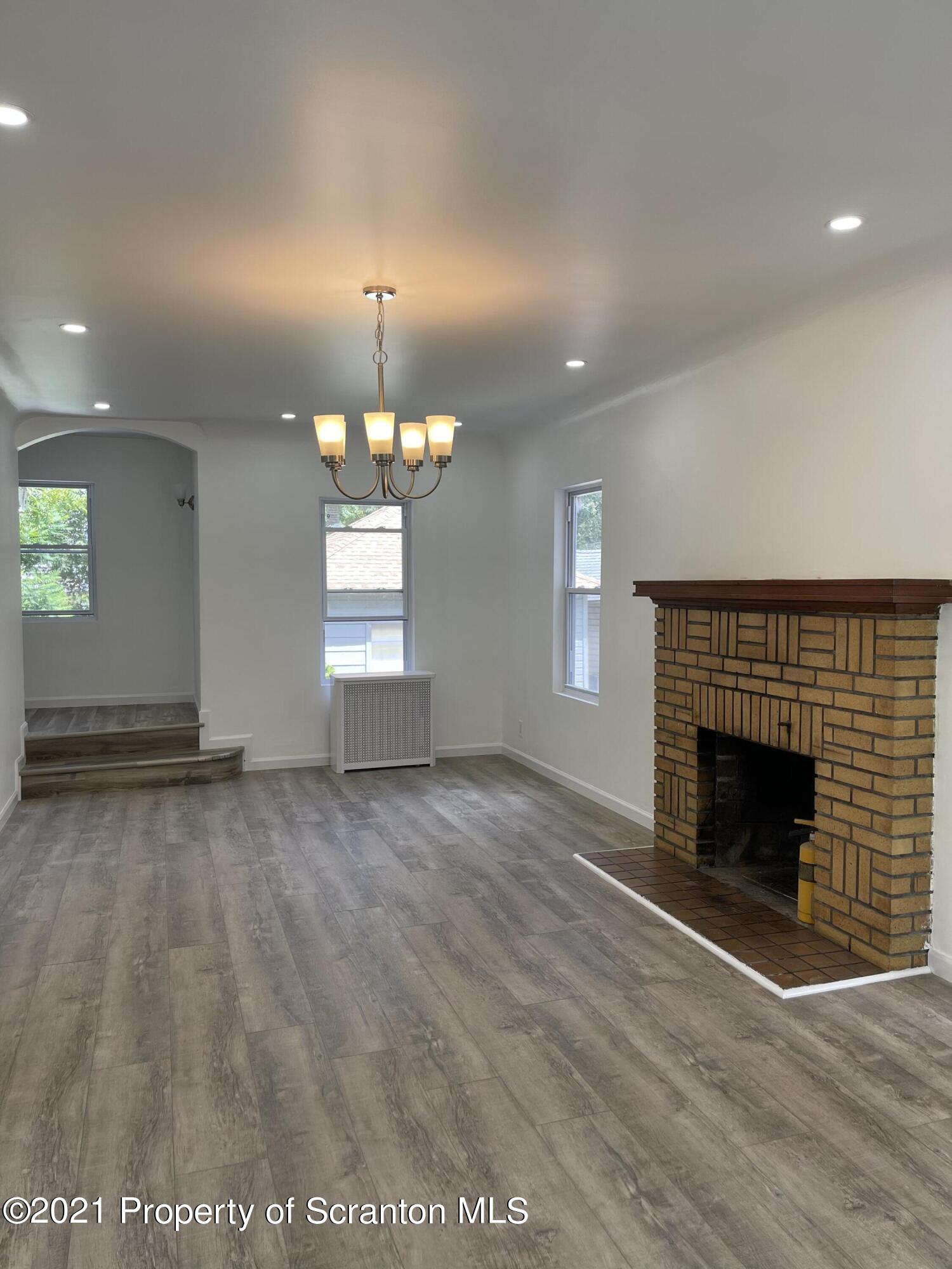 9 Front Street Clarks Summit, PA 18411 - Photo 6 of 22 an empty room with windows and fireplace