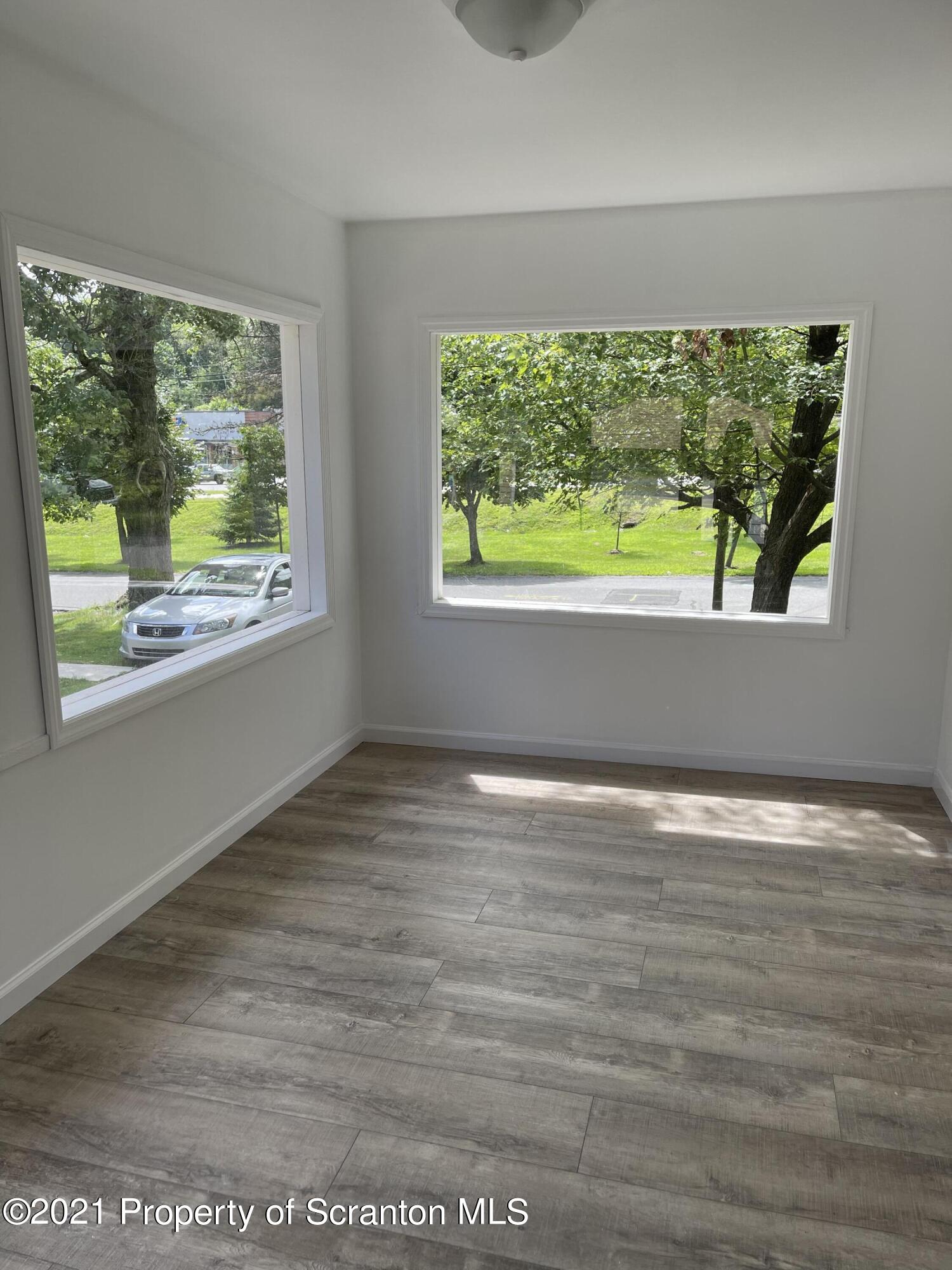 9 Front Street Clarks Summit, PA 18411 - Photo 10 of 22 an empty room with wooden floor and windows