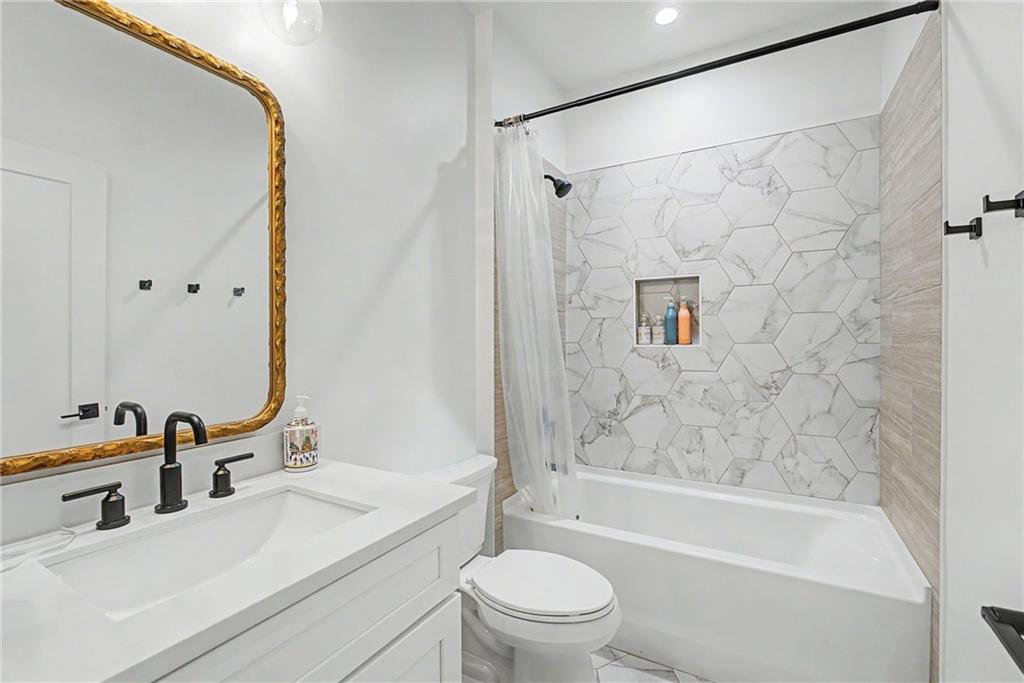 376 Hunnicut Road Southeast Mableton, GA 30126 - Photo 63 of 73 a bathroom with a bathtub shower sink vanity mirror and toilet