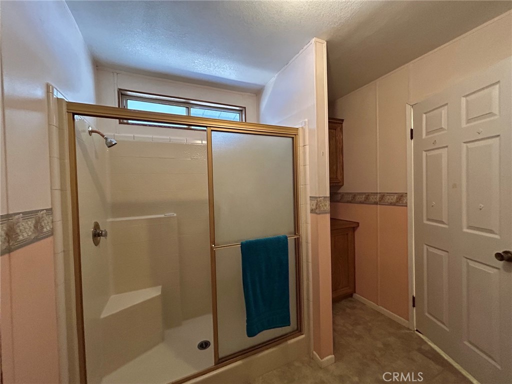 27250 Murrieta Road, Unit 347 Menifee, CA 92586 - Photo 20 of 39 a bathroom with a glass shower door and a sink