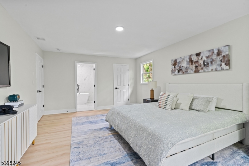 51 Pidgeon Hill Road Wantage, NJ 07461 - Photo 17 of 39 a bedroom with a large bed and a walk in closet