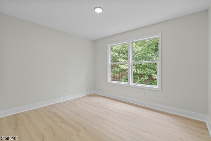51 Pidgeon Hill Road Wantage, NJ 07461 - Photo 24 of 39 an empty room with wooden floor and windows