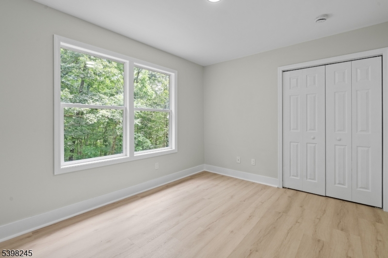 51 Pidgeon Hill Road Wantage, NJ 07461 - Photo 25 of 39 a view of an empty room with wooden floor and a window