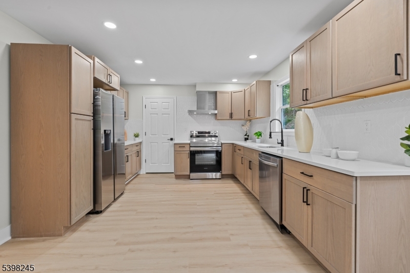 51 Pidgeon Hill Road Wantage, NJ 07461 - Photo 10 of 39 a kitchen with stainless steel appliances a refrigerator sink and cabinets