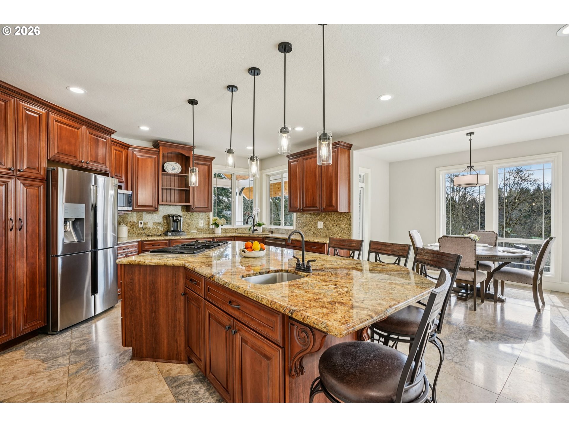 23044 Southwest Ulsky Road West Linn, OR 97068 - Photo 13 of 48 a kitchen with stainless steel appliances granite countertop a stove top oven a refrigerator a kitchen island a dining table and chairs with wooden floor
