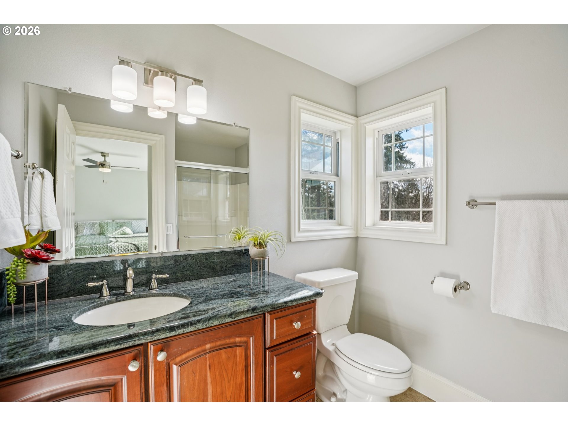 23044 Southwest Ulsky Road West Linn, OR 97068 - Photo 18 of 48 a bathroom with a granite countertop sink mirror vanity and a toilet