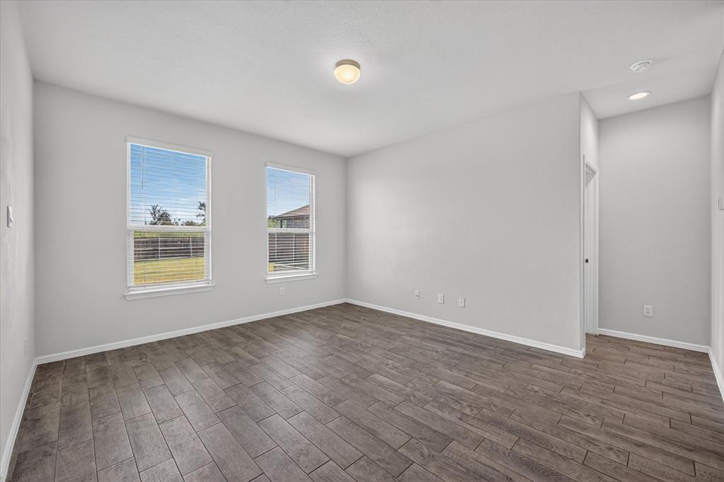 8812 Russano Road Fort Worth, TX 76131 - Photo 15 of 40 Wood-finish flooring, two windows with blinds, recessed lighting, and a flush mount ceiling light