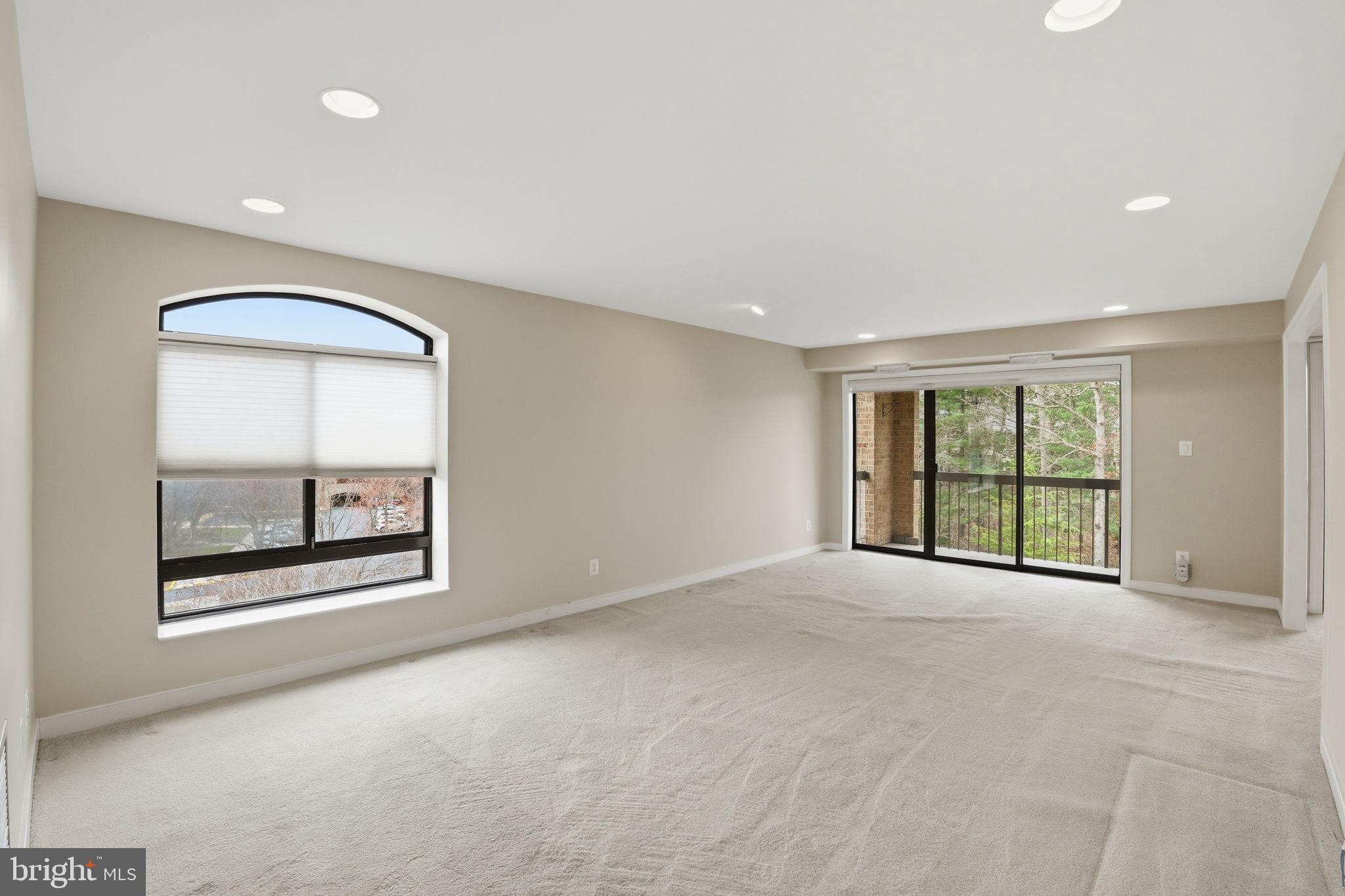 11400 Strand Drive, Unit R402 Rockville, MD 20852 - Photo 7 of 38 Living room is filled with natural lighting