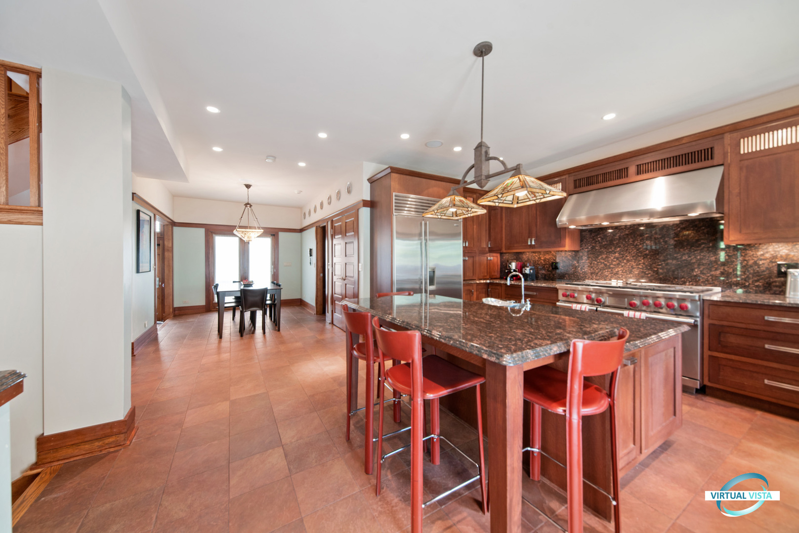 37 Longcommon Road Riverside, IL 60546 - Photo 17 of 34 a large kitchen with stainless steel appliances granite countertop a stove a refrigerator a oven a dining table and chairs with a large window