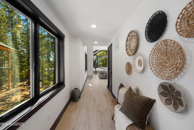 a hallway with chairs and a large window