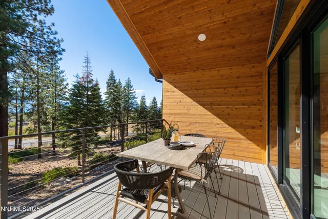 a view of deck with furniture and trees