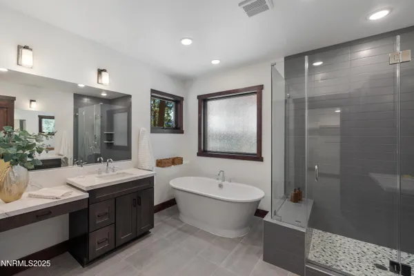 a bathroom with a double vanity sink mirror and toilet