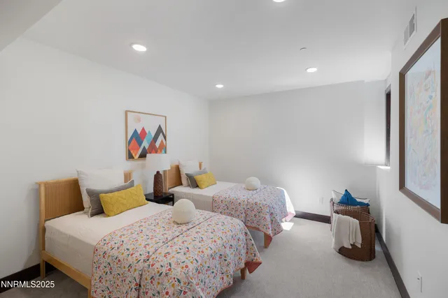 a bedroom with two beds and a dresser