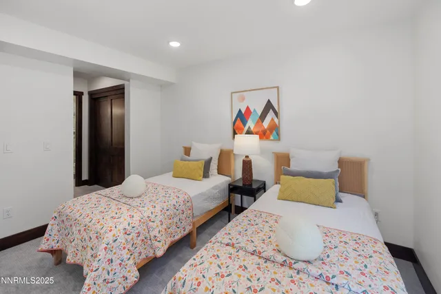 a bedroom with bed and wooden floor