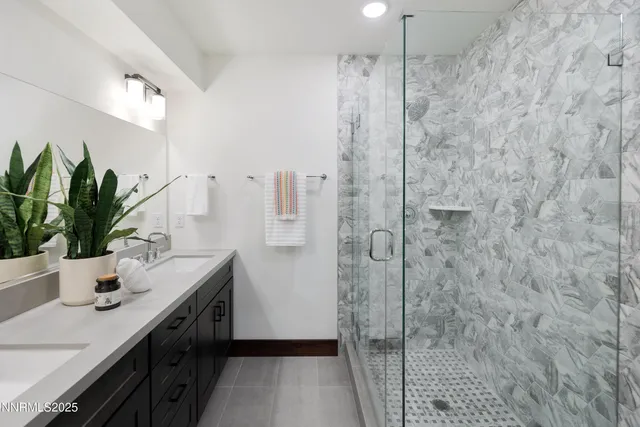 a bathroom with a shower sink and mirror