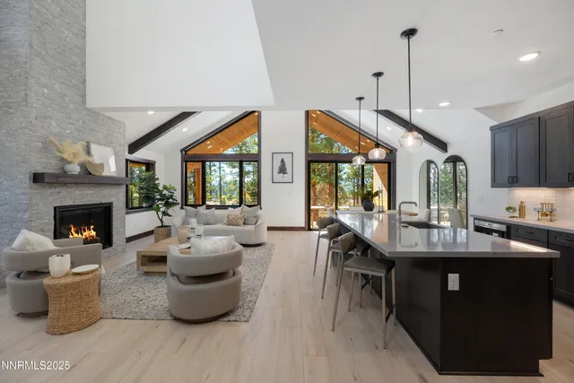 a kitchen with sink and view of living room