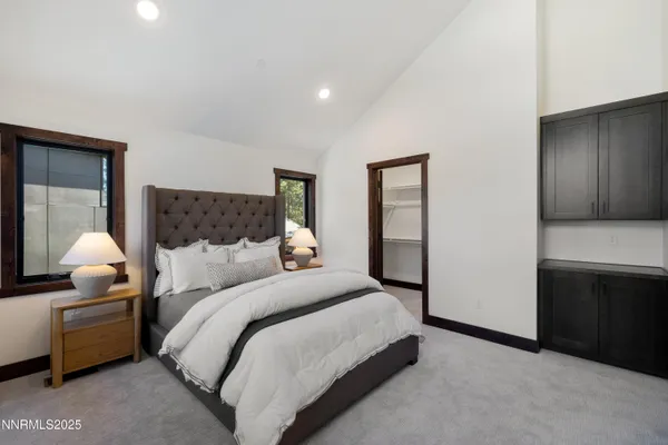 a bedroom with a bed and a lamp