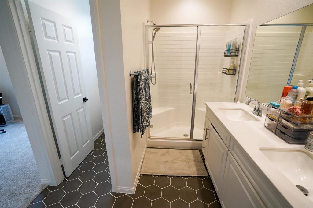 8375 Tahoe Street Lemon Grove, CA 91945 - Photo 21 of 27 a bathroom with a sink a toilet a mirror and shower