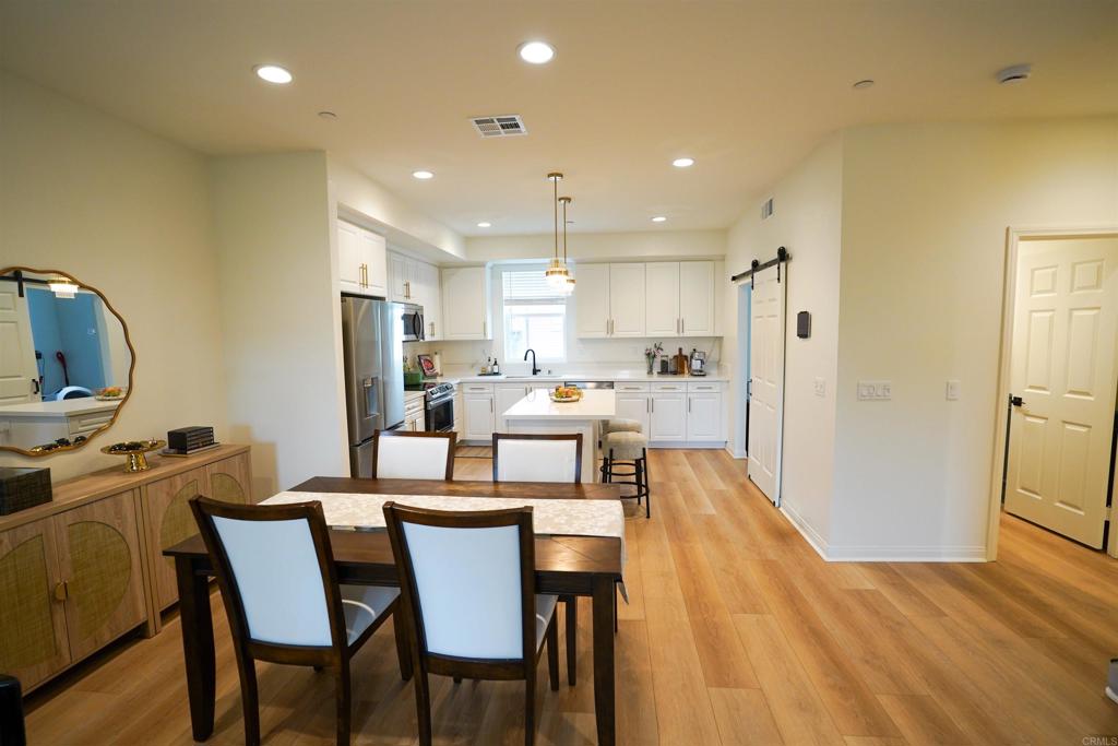 8375 Tahoe Street Lemon Grove, CA 91945 - Photo 3 of 27 a view of a dining room with furniture and wooden floor