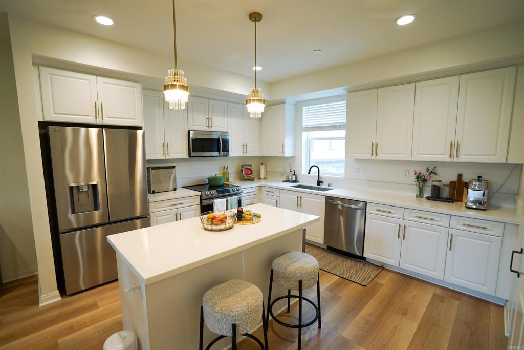 8375 Tahoe Street Lemon Grove, CA 91945 - Photo 5 of 27 a kitchen with a refrigerator a stove a sink and dishwasher