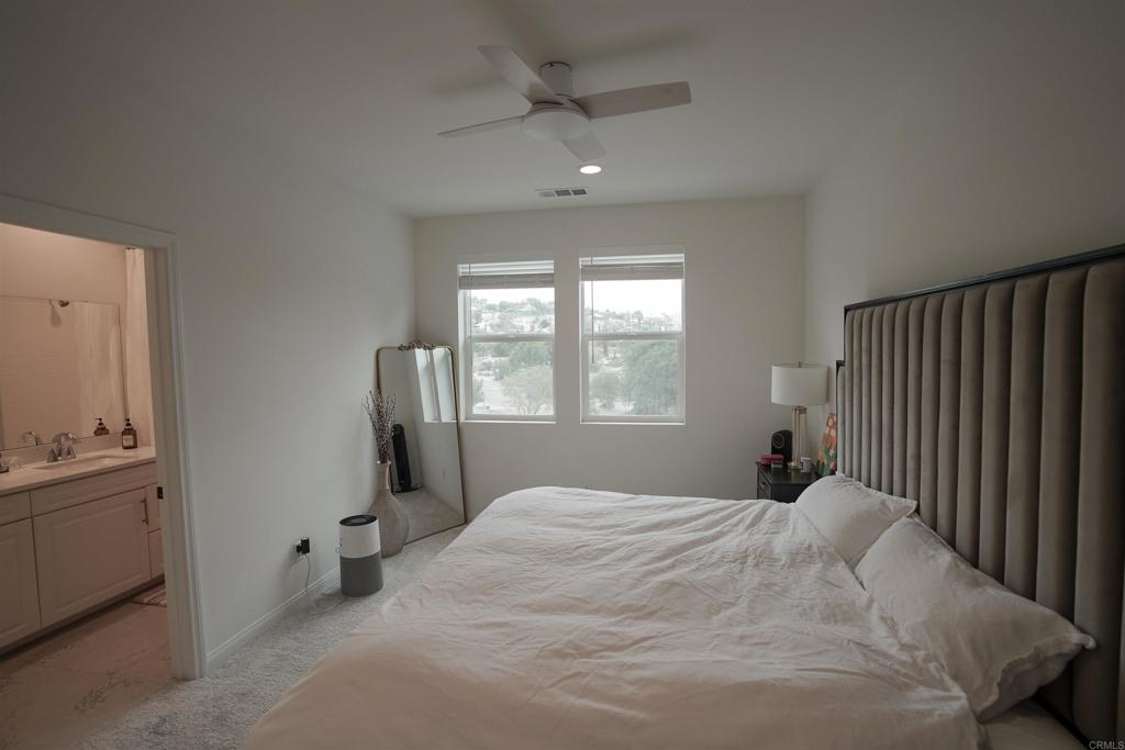 8375 Tahoe Street Lemon Grove, CA 91945 - Photo 6 of 27 a bedroom with a bed and a chandelier