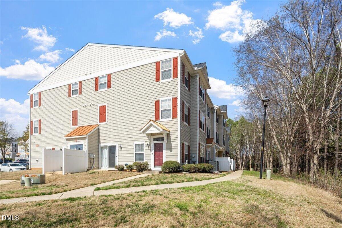 2231 Raven Road, Unit 103 Raleigh, NC 27614 - Photo 4 of 26 a view of a house with a yard