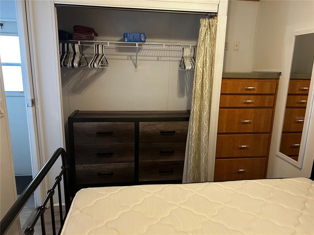 6946 Old Pasco Road, Unit LOT 1 Wesley Chapel, FL 33544 - Photo 9 of 16 a bedroom with a bed and a dresser