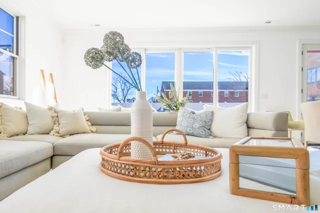 a living room with furniture and a chandelier