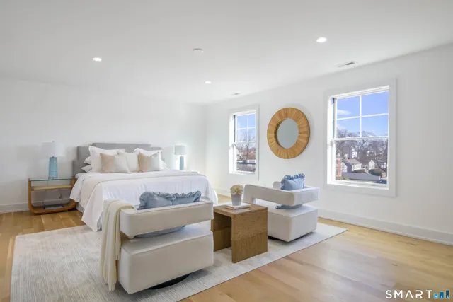 a bedroom with a bed and painting on the wall