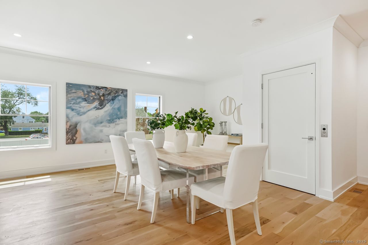 345 Reef Road, Unit B6 Fairfield, CT 06824 - Photo 7 of 40 a view of a dining room with furniture and wooden floor