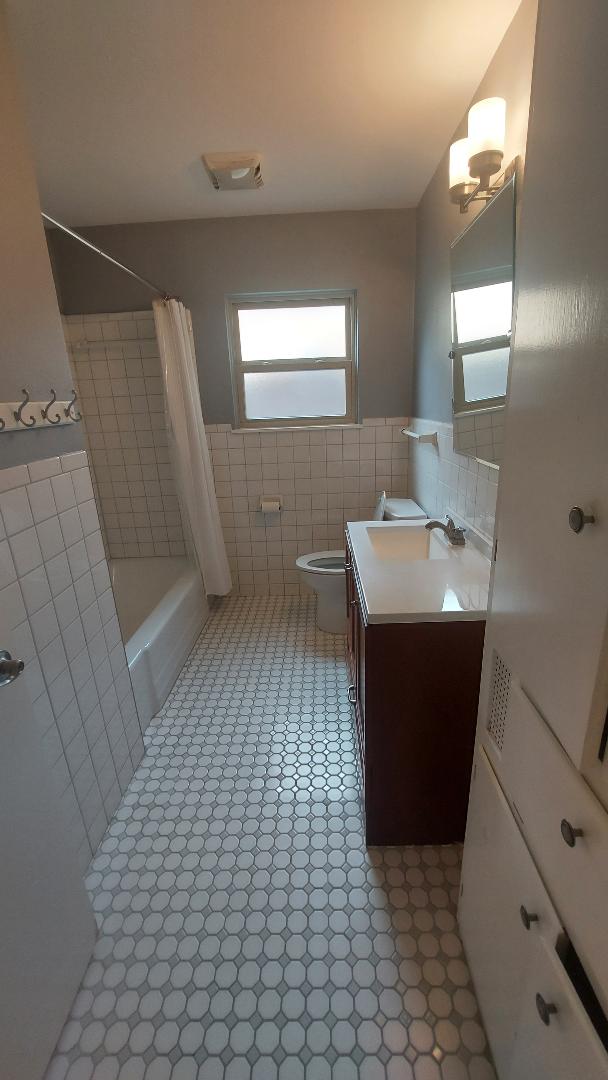 1807 Barbara Street Austin, TX 78757 - Photo 24 of 25 a bathroom with a sink a toilet and mirror